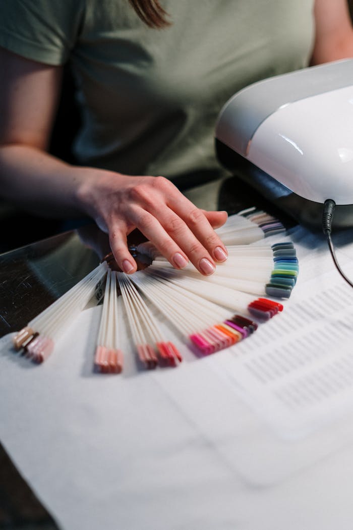 A client selects a color from a gel polish palette in a modern nail salon.